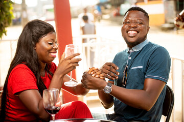 a happy young couple outside a bar.