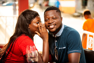 Close-up of a romantic couple outside a bar.