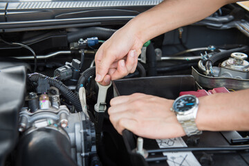 Maintenance,mechanic examining car breakdown under hood of car