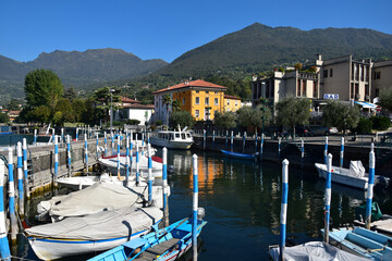 Fototapeta na wymiar The small town Sulzano at Lago d'Iseo with a little harbor and boats. Brescia, Lombardy, Italy.