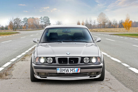 Chernigov, Ukraine - November 8, 2017. BMW M5 (E34) with the numbers "BMW M5". Gray BMW stands on the road