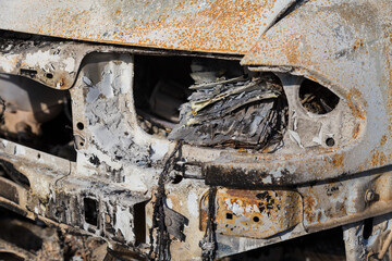 Burned down car, abstract background, selective focus. The situation of protests in the world.