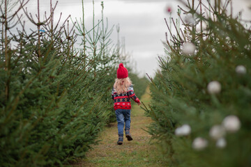girl with long blond hair in the woods Christmas tree