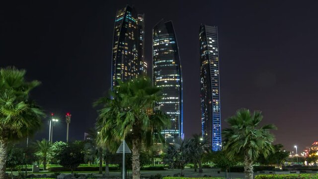 Skyscrapers of Abu Dhabi illuminated at night with Etihad Towers buildings timelapse hyperlapse. Abu Dhabi is the capital and the second most populous city of the United Arab Emirates
