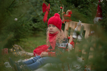 girl with long blond hair in the woods Christmas tree