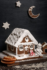 Traditional baking. Gingerbread house and gingerbread stars,. Vertical frame