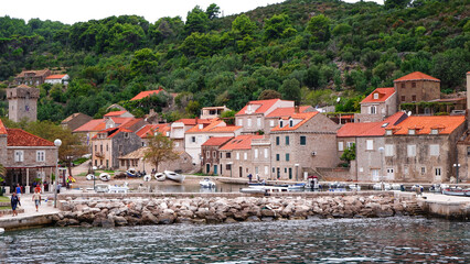 Sipan island panoramic view from the boat. Red rooftop houses on Sipan island with its port and mountains