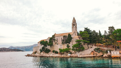 View of the church on Lopud Island near Dubrovnik. view of the church and tower on Lopud island from the boat without people