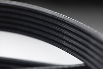 New belt for automobile poly-V-belt electricity generator. Macro close-up blank for background