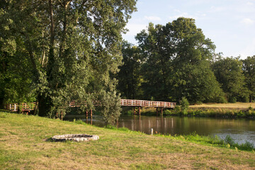 Footbridge over Bobr river at park of Princely palace in Zagan. Poland © Andrey Shevchenko