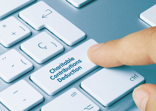 Charitable Contributions Deduction - Inscription On Blue Keyboard Key.