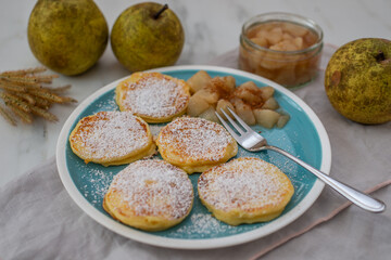 home made pancakes with cooked pears on a table
