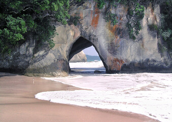 Secret Paradise Beach Cave. Location is a remote beach among lime stone rocks called Cathedral Cove in New Zeeland - 397398879