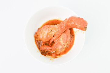 Spicy chicken with chili sauce in the white bowl. Delicious food.