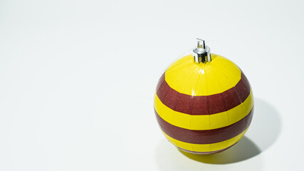 Yellow and maroon Christmas Ball decoration. Close-up