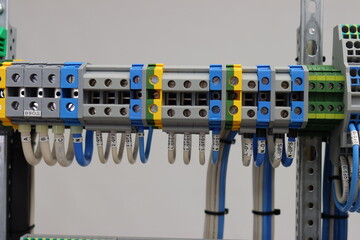 Pass-through terminals for connecting loads in electrical panels