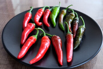 Life cycle of peppers. Stages of red hot pepper growth from green to red. Hot ripen chili peppers without GMO. Nature. Organic Mexican or Turkish spices. It is called 