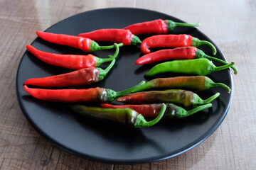 Life cycle of peppers. Stages of red hot pepper growth from green to red. Hot ripen chili peppers without GMO. Nature. Organic Mexican or Turkish spices. It is called 