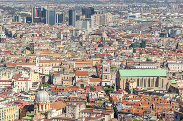 Obraz premium Naples, Italy - a Unesco World Heritage old town, Naples displays also a modern business center, here dominated by Mount Vesuvius on the background 