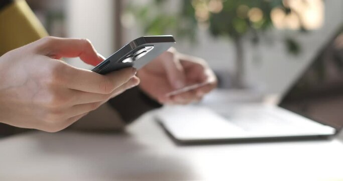 Female hand holding credit card and shopping online. Easy pay using digital gadget. Girl using laptop at home. Happy woman with smartphone and bank card shopping online. Buying gifts. Lifestyle 4K