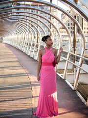 Young black woman wearing a party dress on the street, full shot