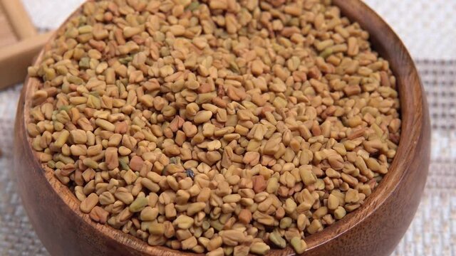 Dry fenugreek seeds close-up selective focus. healthy food