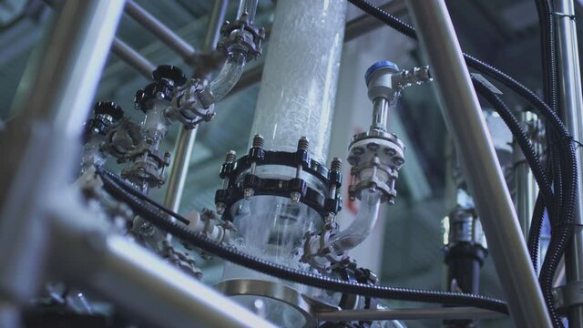 Water pump and pipes. Transparent pipe to show water flows inside the water supply system.