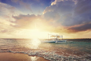 Naklejka premium Beautiful colorful sunrise on the seashore with fishing boats. Philippines, Siargao Island.