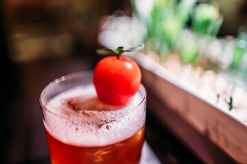 glass with cocktail and ice on the bar