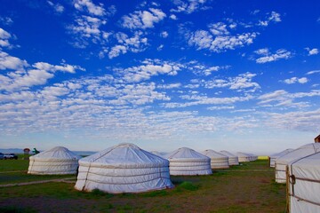 Tourists gher camp below blue sky, Mongolia 
