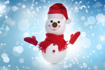 Cute decorative snowman on light blue background, bokeh effect