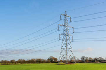 Electricity pylon in a field with blue sky. Bishop's Stortford, Hertfordshire. UK