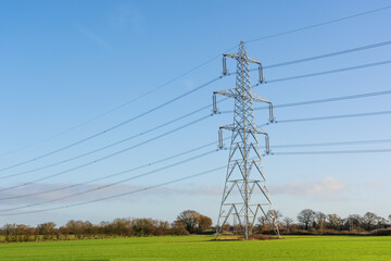 Electricity pylon in a field with blue sky. Bishop's Stortford, Hertfordshire. UK