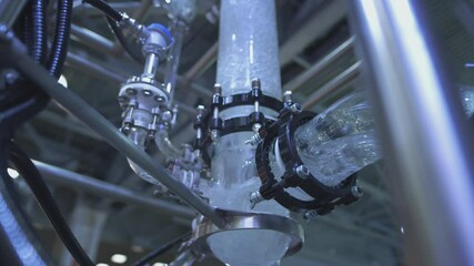 Water flows in a transparent pipe. Transparent pipe to show water flows inside the water supply system. Testing of pumps for oil flow