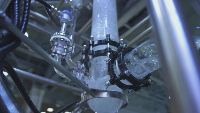 Water flows in a transparent pipe. Transparent pipe to show water flows inside the water supply system. Testing of pumps for oil flow