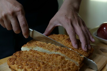 person slicing bread