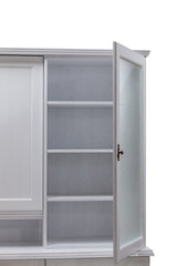 Open door of a white wooden kitchen cabinet with shelves.