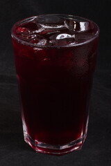 Cherry juice with ice cubes in a glass Cup