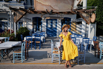 Travel and active lifestyle concept. Young traveller woman walking in old town with sidewalk cafes.