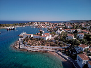 Fototapeta na wymiar Aerial shot of Spetses Island coast in Greece. A famous tourist destination on the Aegean sea. Old town and harbour view.