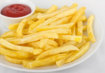 French fries with ketchup, served on a white plate