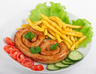 Chicken sausage with French fries, tomatoes, cucumbers and lettuce