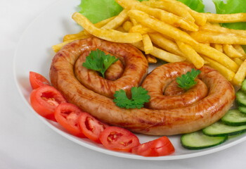 Chicken sausage with French fries, tomatoes, cucumbers and lettuce