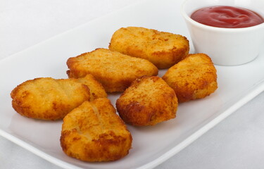 Six slices of chicken nuggets with ketchup