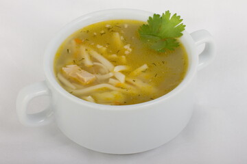 Chicken noodle soup in a white tureen