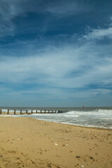 View on the North Sea at Horsey Gap. Waves and groins in Norfolk. East coast of UK. photographed n a sunny day in April  2017