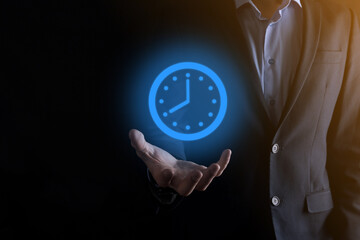 Businessman hand holds the icon of hours clock with arrow. Rapid execution of the work.Business...