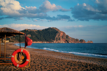 Beautiful landscape. Traveling by Turkey. Cleopatra Beach with sunloungers and umbrellas.