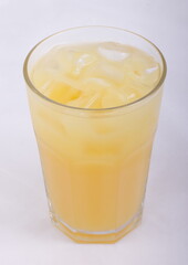 Pineapple juice with ice cubes in a glass Cup