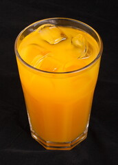 Peach juice with ice cubes in a glass Cup